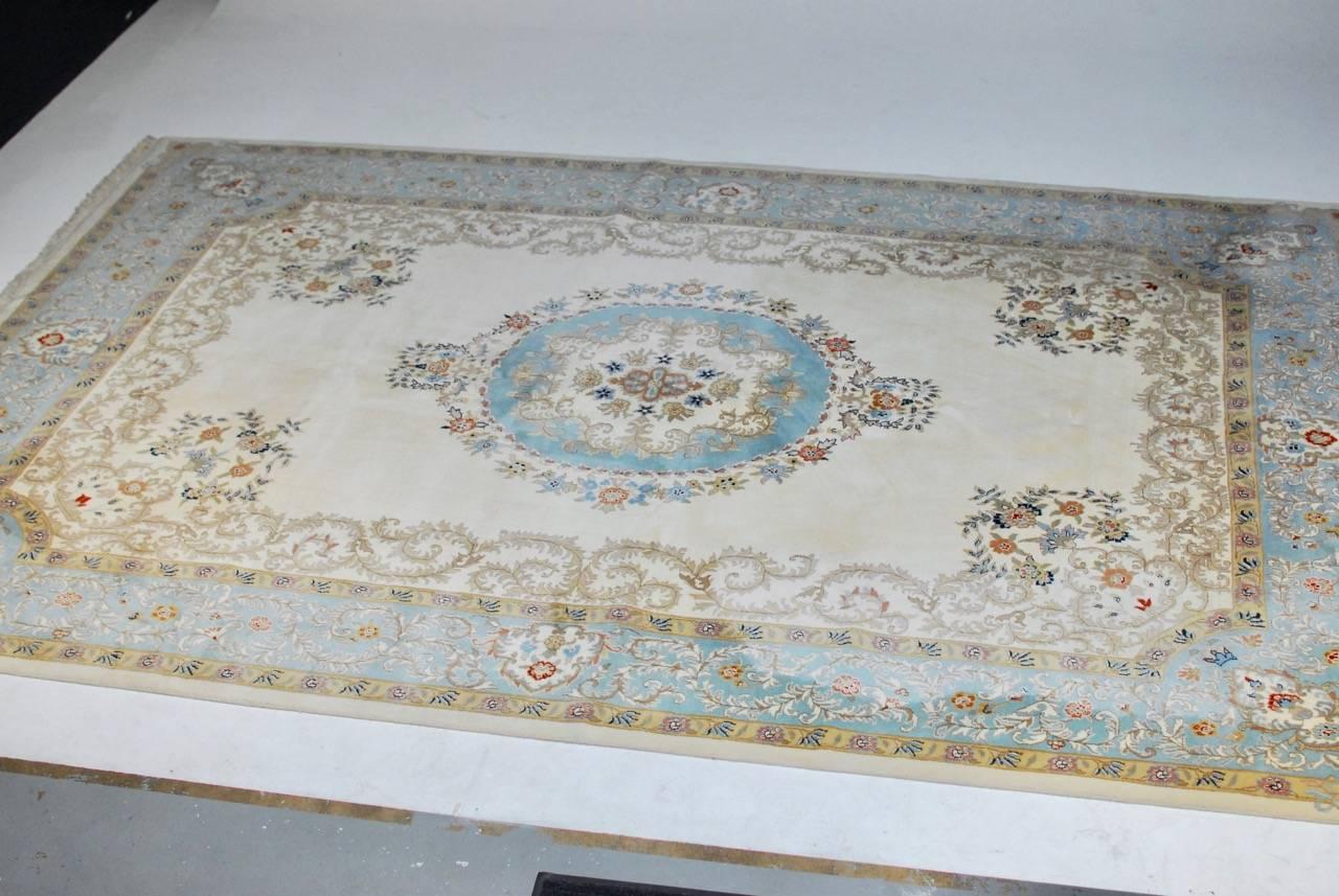 Exquisite Kerman rug featuring a rare turquoise blue over a cream background. Hand-knotted with a soft wool pile and a cotton foundation. Elegant rug made with a deep full high pile.
