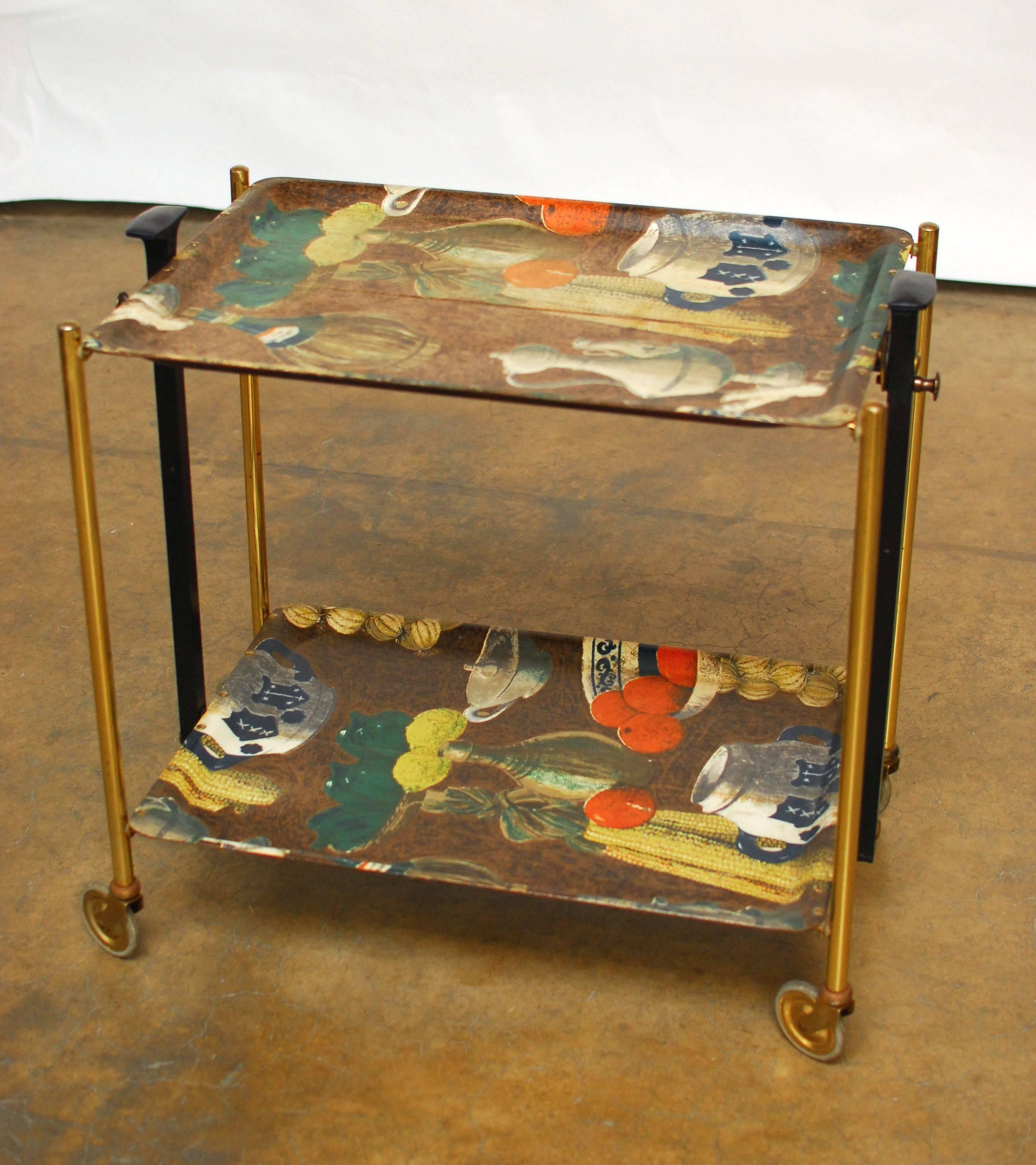 Unique, mid-century modern folding tea cart designed by Gerlinol with formica shelves and a metal frame that collapses for storage. Made in Germany by Bremshey in the 1950's. Rare style with European culinary artwork on the top panels. Rolls on its