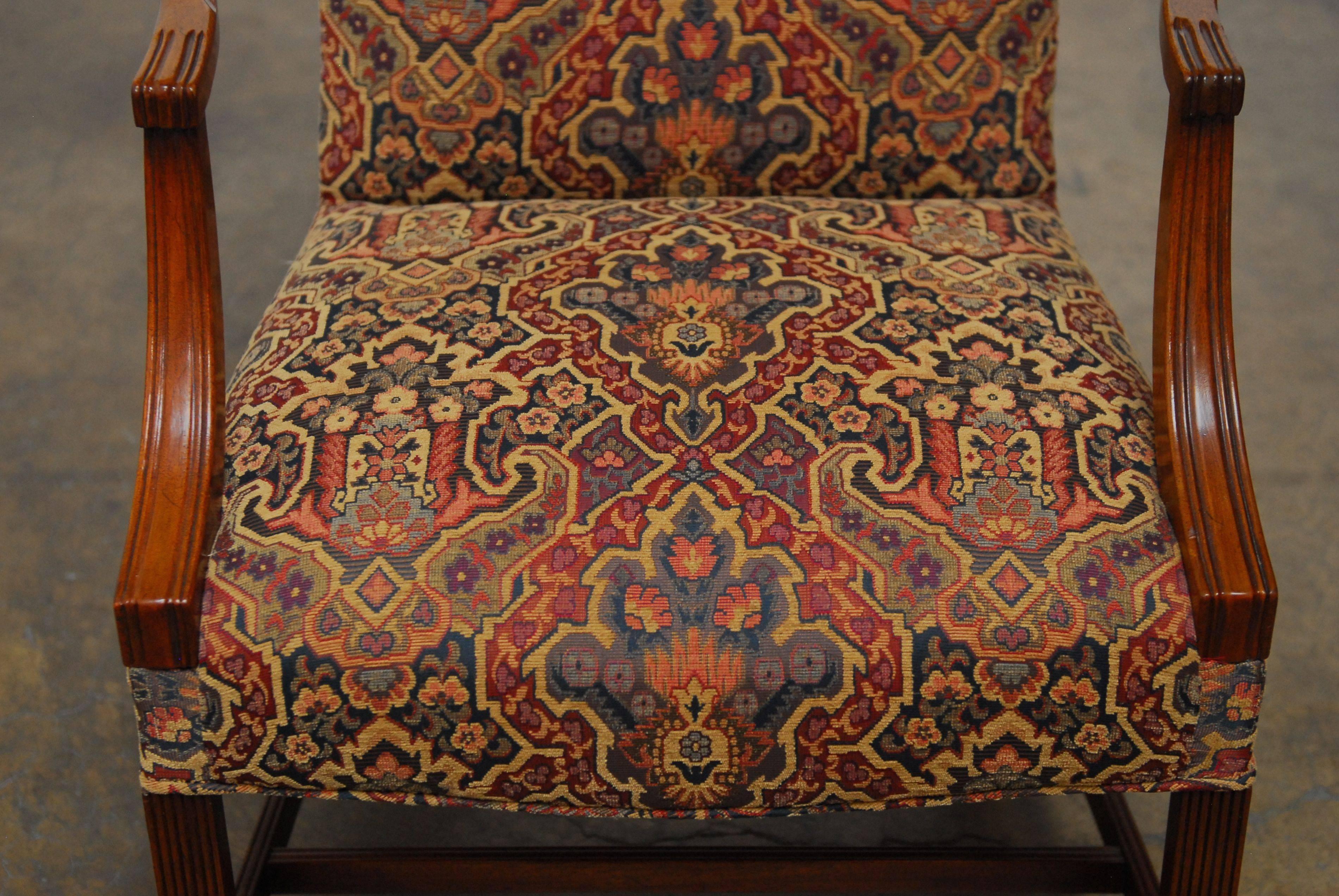 Classic Federal style Lolling chair or library chair constructed from Mahogany with a tapestry style upholstery. Features a serpentine crest and arms. Rising on square legs and stretchers. This is the same style chair that graces the white house