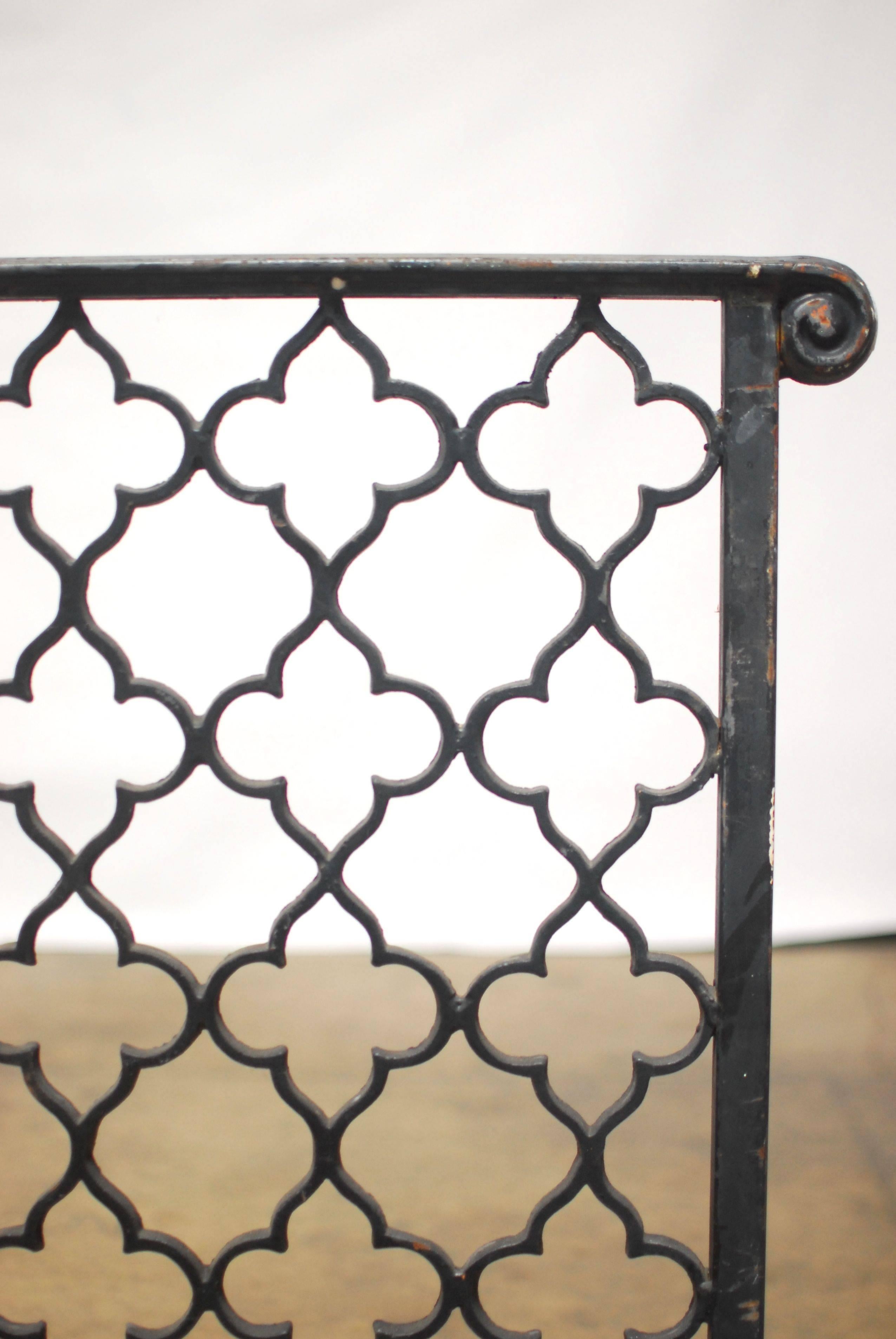 19th century French church altar railing made with a quatrefoil Gothic pattern. Constructed of wrought iron and divided into two sections topped with a thick scrolled hand railing. Beautiful pattern made in symmetrical fence sections. Would make an