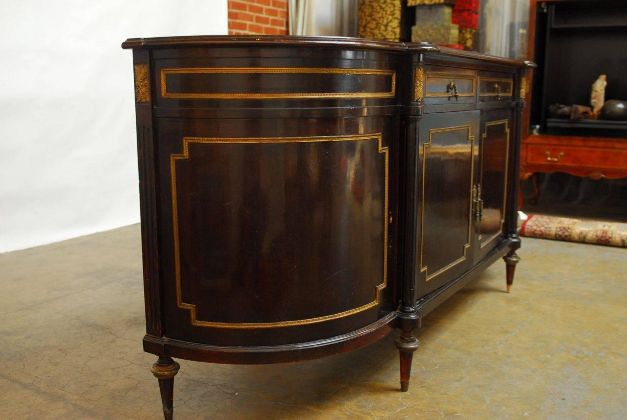 Rare French Louis XVI style bow-front buffet sideboard made of mahogany featuring delicate ormolu mounted bronze embellishments. In original, unrestored condition with a deep, dark mahogany finish. Flanked by convex side doors and supported by