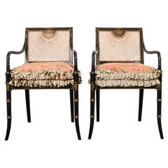 Pair of English Regency Style Ebonized Caned Elbow Chairs