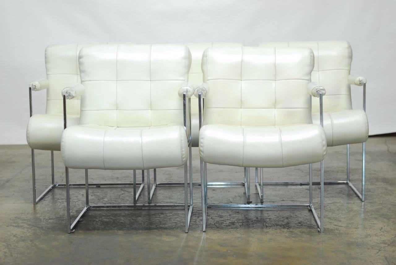 Magnificent set of ten dining armchairs by Milo Baughman for Thayer Coggin featuring thin-line square tubular frames with a sleek, thick chrome finish. Upholstery is worn, mismatched, and needs replacing. All the chairs have thick padded cushions