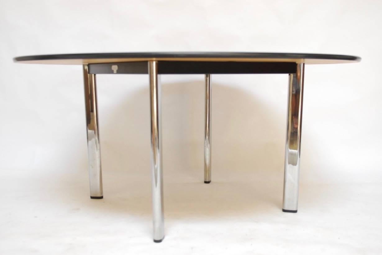 Large round dining table featuring an American Cherry finish designed by Joseph D'Urso for Florence Knoll. The table is supported by a metal base with four chrome legs and a thick protector around the edge. Signed, stamped and dated on frame.