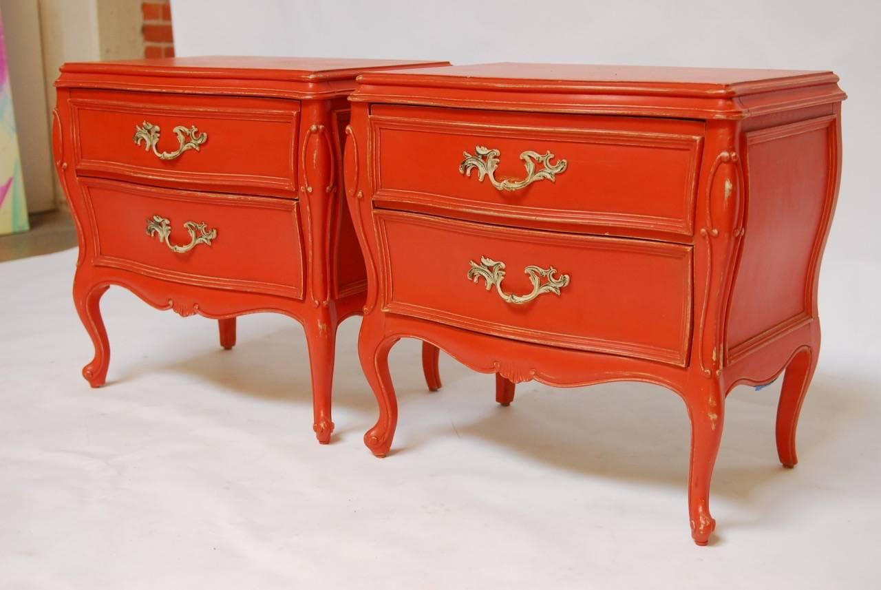 Stunning pair of Mid-Century French Provincial style nightstands or bedside tables featuring a Hermes orange lacquered finish over a grey base. Made by Century Furniture Company with cabriole legs and scrolled feet in the Louis XV taste.