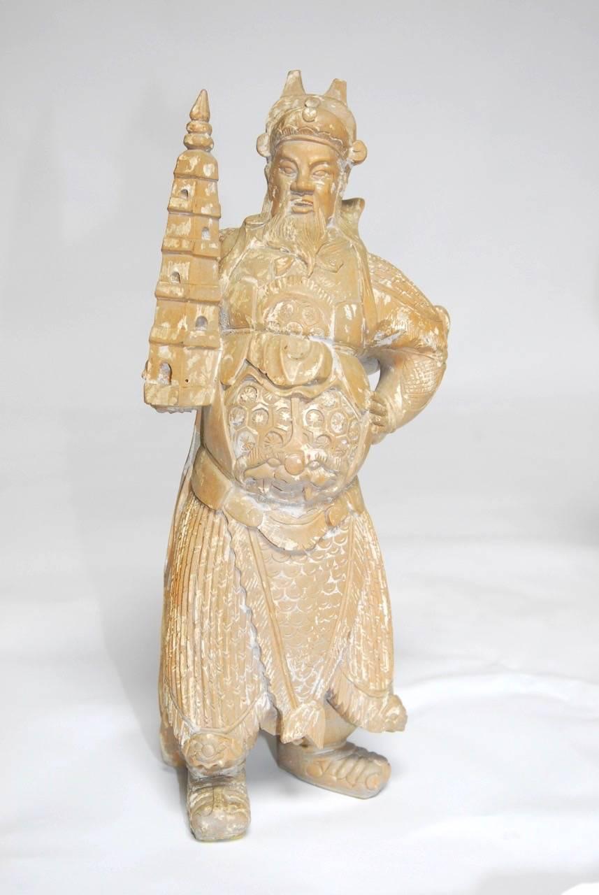 Large set of three Chinese hand-carved statues of immortals depicted standing and each holding an item from Chinese Mythology. These Feng Shui Gods of wealth have a whitewashed finish on the wood and are wearing elaborate warriors outfits.