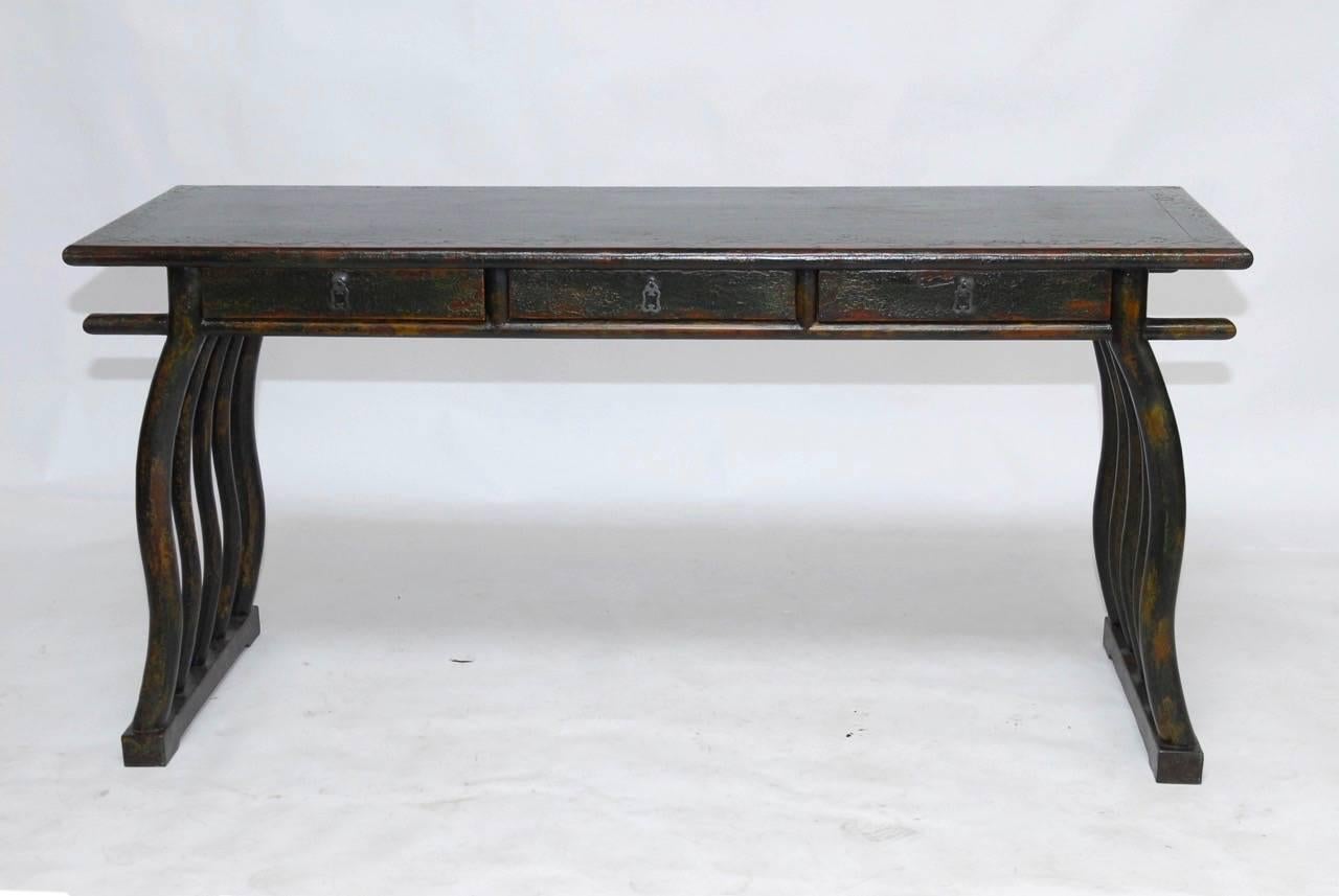Rare and unusual Chinese writing table or scroll viewing table from Shanghai made in the Chinese Deco style. Fronted by three drawers, supported by five serpentine legs on each side and conjoined with a stretcher. This desk features a beautifully