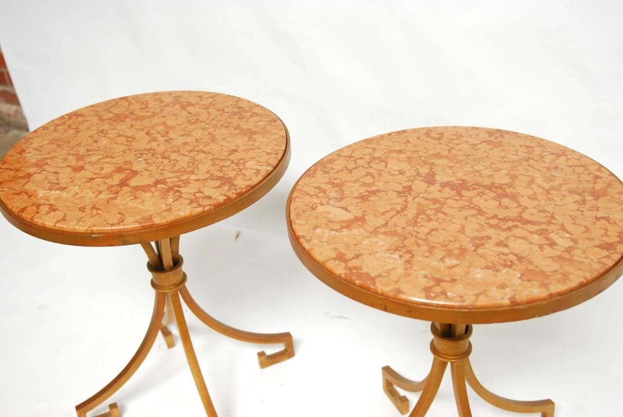 Stunning pair of Italian wrought iron and marble Gueridon side tables or drinks tables made in the neoclassical taste with Greek key shaped feet. Featuring a 1