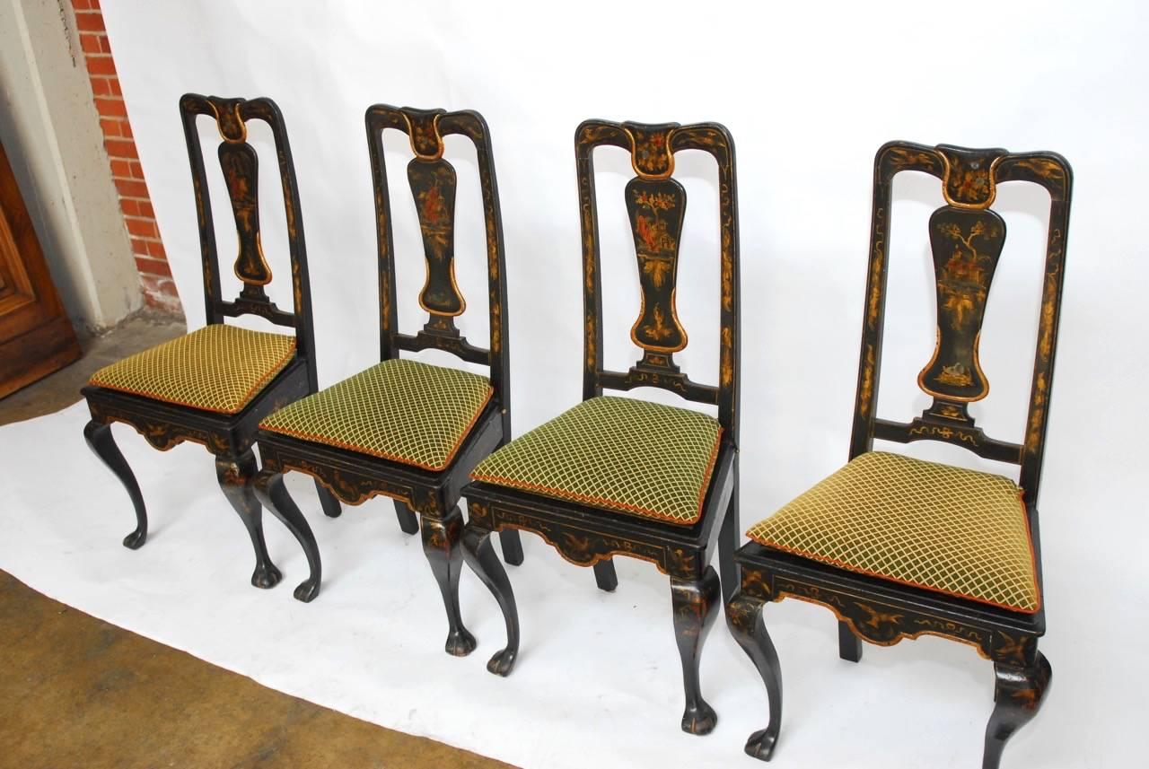 Fantastic set of four chinoiserie painted dining chairs made in the Queen Anne taste. Featuring hand-carved frames decorated with pagodas and a different bird motif on the seat apron. Hand-painted with red lacquer and gilt over a black ground. Each