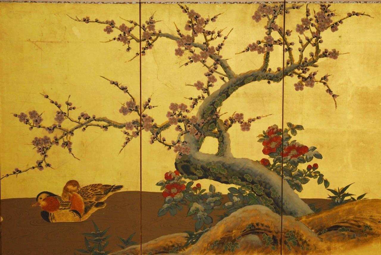 Colorful Japanese four panel byobu folding screen depicting a pair of ducks near a prunus blossom flowering tree. Bordered by silk and set into an ebonized wood frame. Beautifully painted on gold leaf squares from an estate in San Francisco, CA.