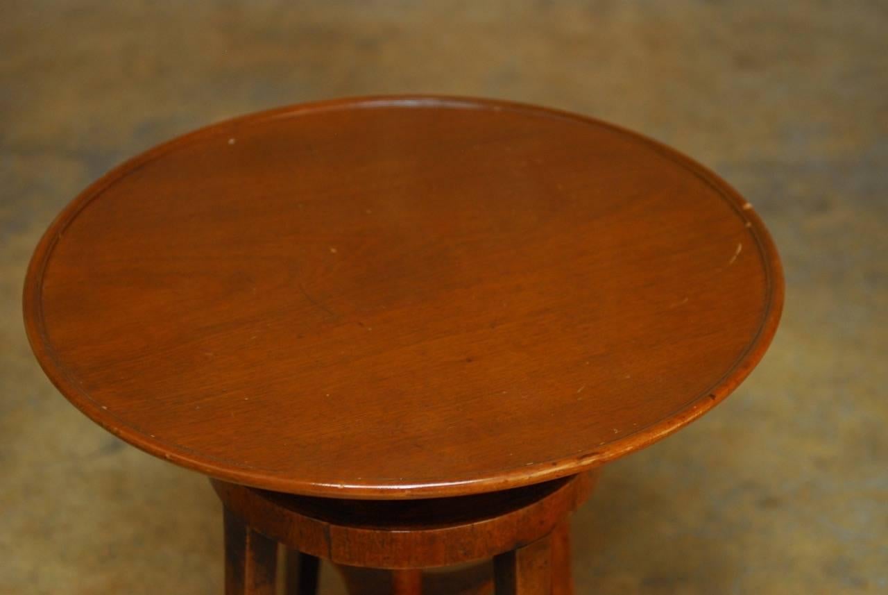 Rare mahogany wine table featuring an adjustable height top that turns down to 17