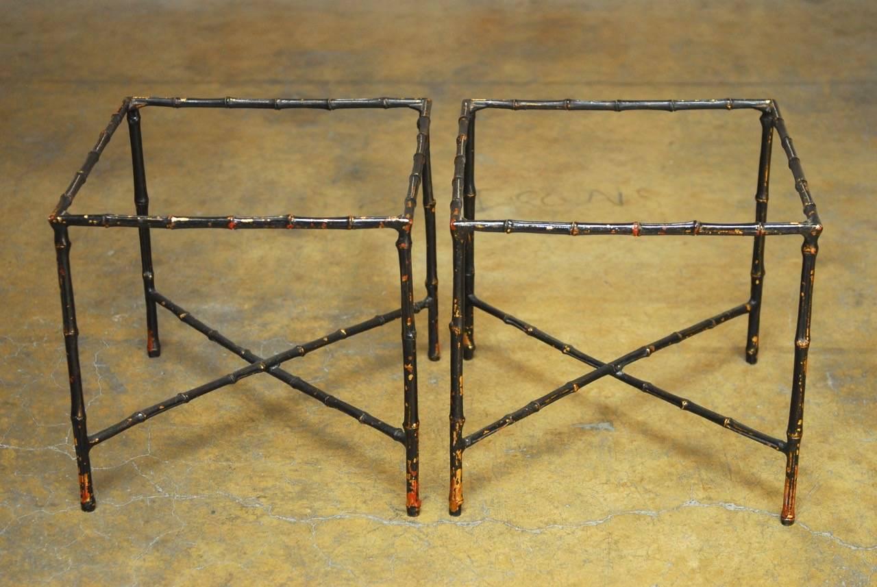 Fantastic pair of Italian black lacquered metal faux bamboo drinks tables featuring a hand-applied gold leaf finish. This pair of side tables made in the manner of Maison Bagues with metal frames and decorative cross stretchers. Does not include