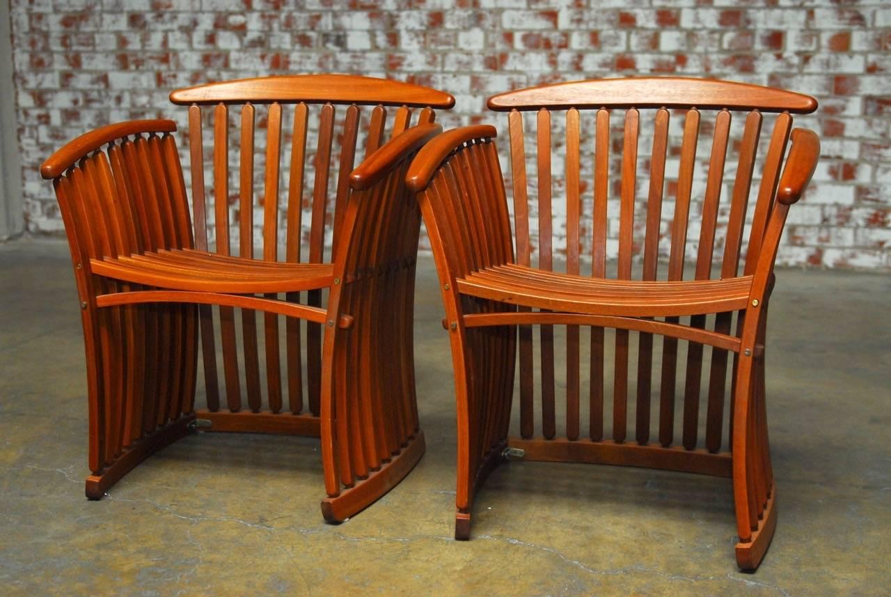 Organic modern pair of bentwood steamer armchairs by Canadian designer Thomas Lamb featuring bentwood construction with graceful slatted wooden arcs that curve and can be folded down flat for storage. Thomas Lamb's steamer bentwood designs have a