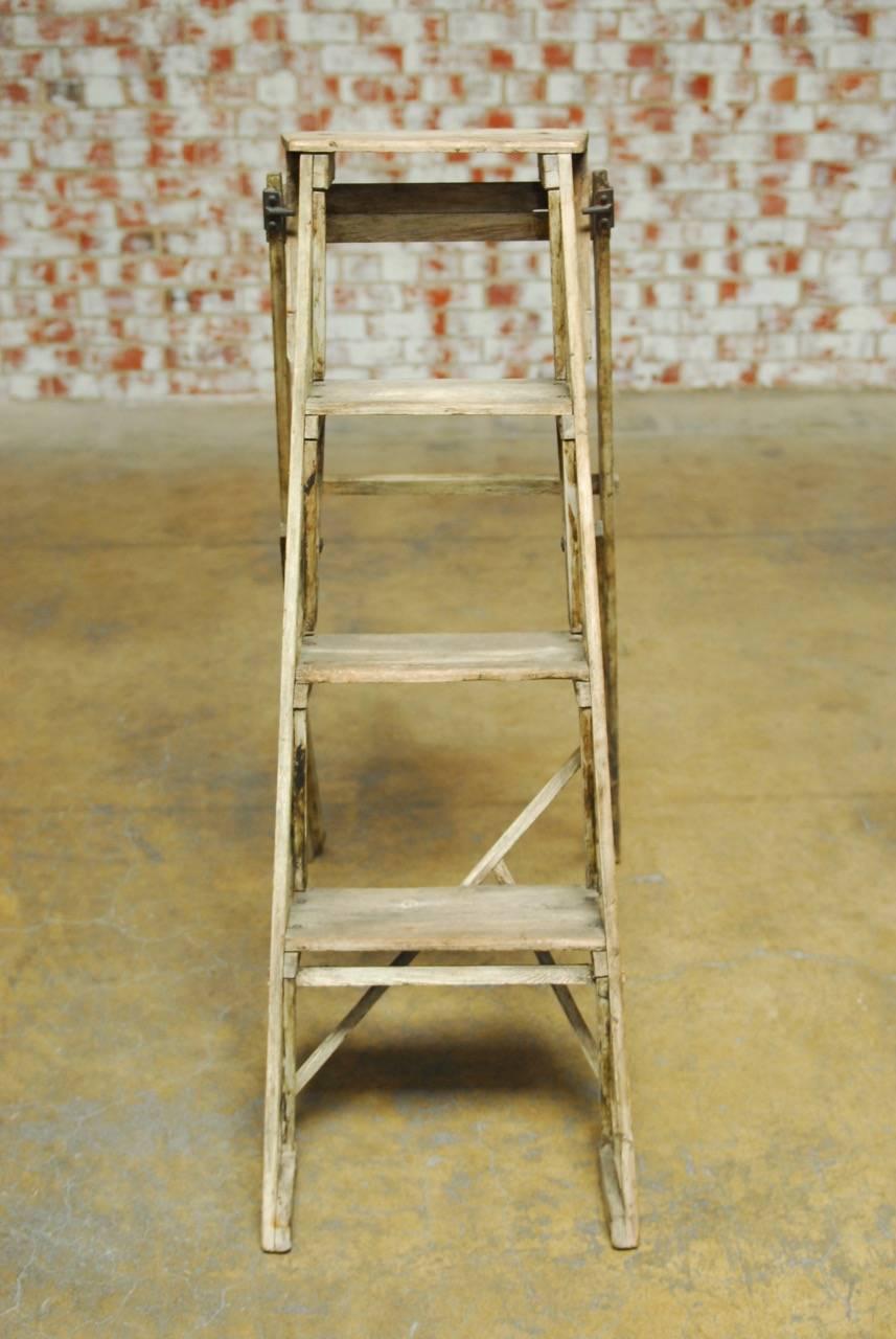 Rare 19th century English "Hatherley" lattice step ladder by "Gainsford and Company" London, England. Constructed from ash with four steps and finished with oil and wax polish. Bears a metal maker's plaque on both sides and folds
