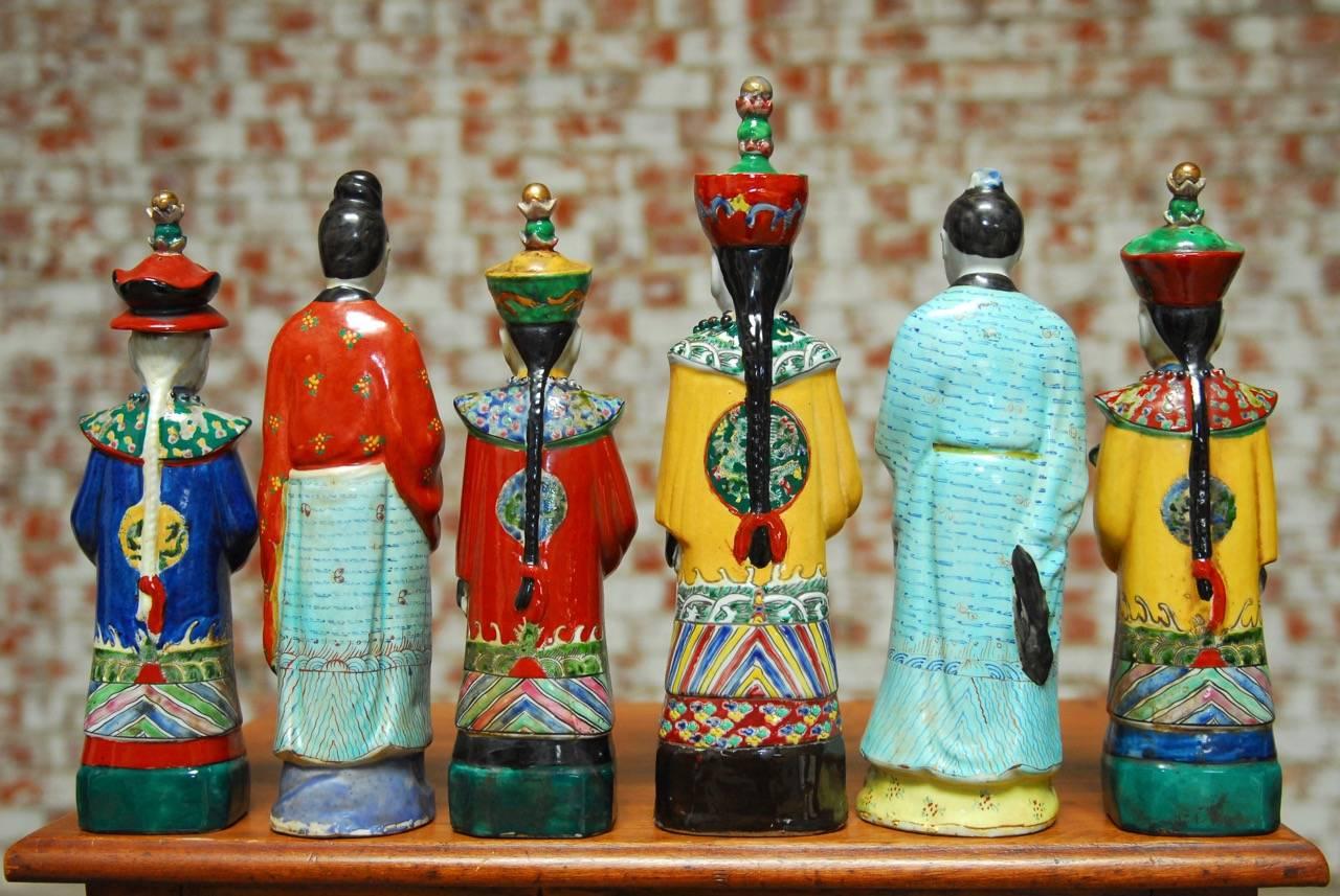 Colorful set of six Chinese porcelain Qing Emperor, Royal and Monarch figural group. Glazed in a wucai style with flamboyant robes and hats. Each has stamp on bottom from Qing periods but probably all Chinese export. All vary in height between 13-14