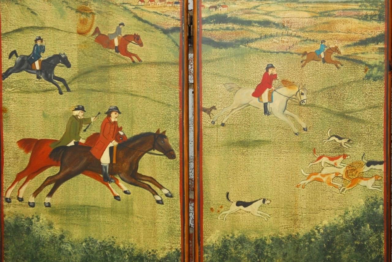 Beautiful English Victorian hand-painted wooden dressing screen or room divider. Features a painted four panel front depicting an idyllic English fox hunt landscape scene with horsemen and dogs. Each panel is constructed from solid wood planks with