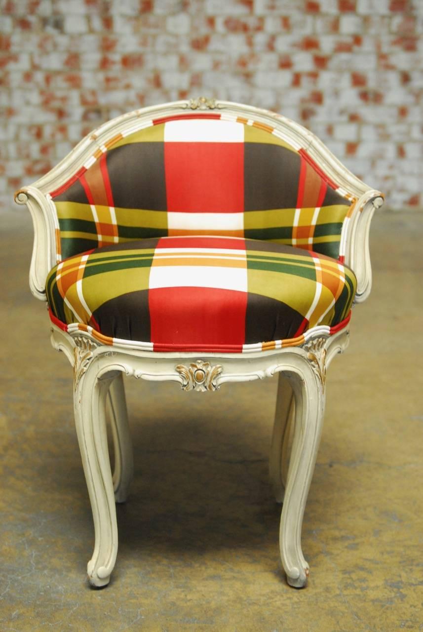 Louis XV style painted boudoir vanity stool with carved cabriole legs. Featuring a Burberry style silk plaid upholstery with a double welt border. Classic floral and foliate carved details on the legs.