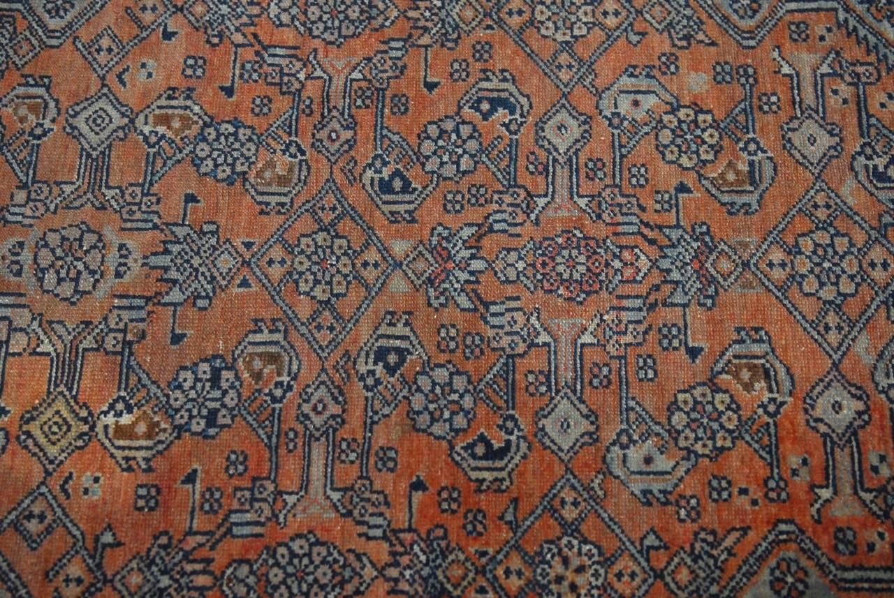 Stunning antique Persian Hamadan carpet made in the tribal style featuring a unique color palette of dark indigo blue and light blue with rust. Beautiful, geometric patterns with tribal design made of soft, hand-knotted wool.