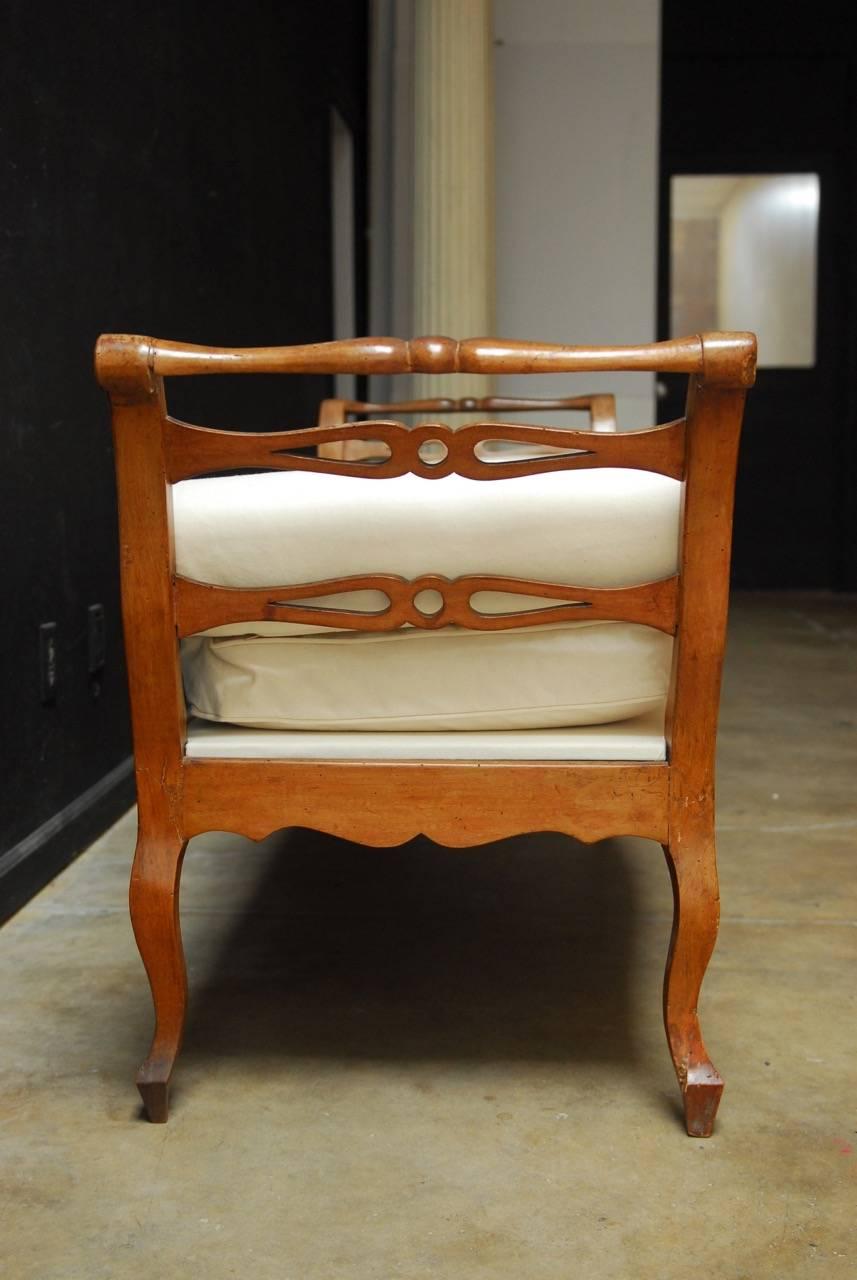 Gorgeous 19th century, French Provincial carved daybed featuring a fresh canvas upholstery. Elegant carved frame with scrolled ends that were attached with a backrest, now redesigned as a recamier style bed. The front has a bowed apron with a