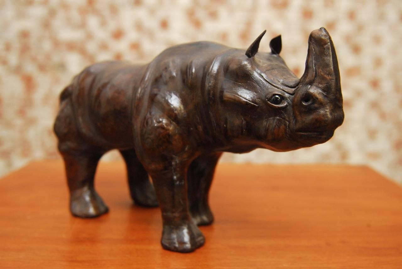 Impressive midcentury leather wrapped rhino culture featuring a vintage life-like leather with fine details. Glass eyes and pointed ears with a dark brown color.