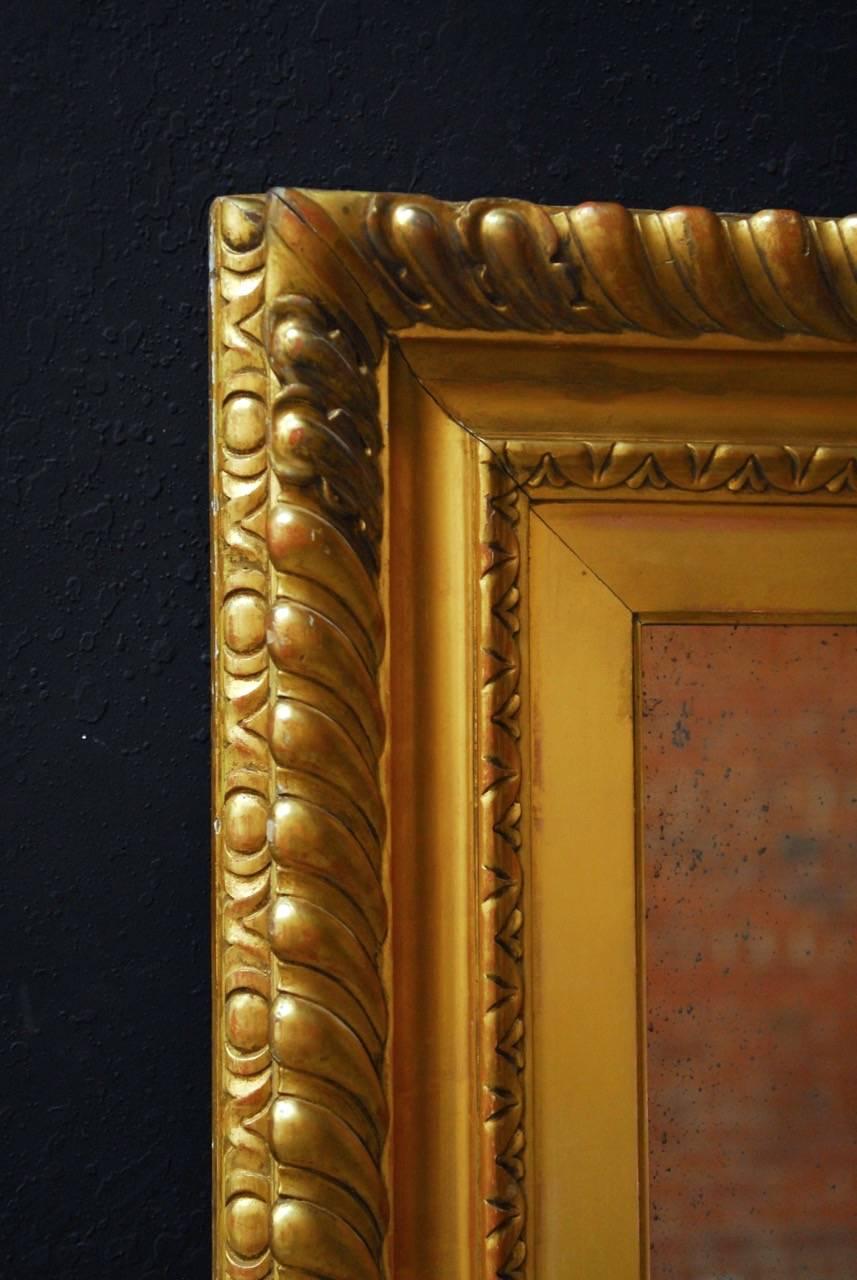 Magnificent 18th century English giltwood or gold leaf carved mirror made in the Rococo taste. The hand-carved frame originally housed a large portrait and was converted to a mirror soon after. Painstakingly mounted and given a gold leaf finish. The