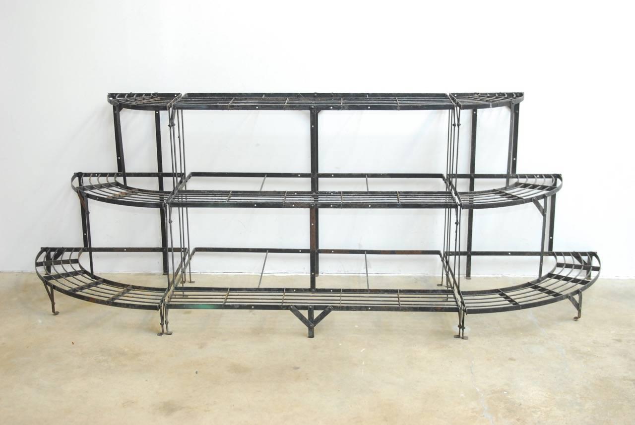 Impressive French Art Deco three-tier metal demilune plant stand. Featuring a three section frame with 6.5 inch wide shelves. The middle section is 39 inches wide and each end piece is curved. Drawing inspiration from the visual arts movement, this