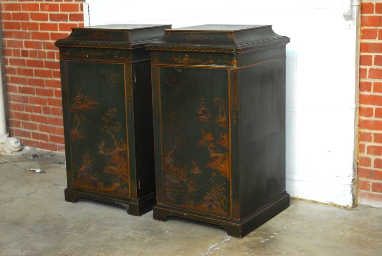Rare pair of English green lacquer pagoda cabinets with a japanned finish made in the Chinoiserie revival of the late 19th century. Each cabinet is fronted by a large door and topped with a decorative pagoda shaped roof. Beautifully painted with