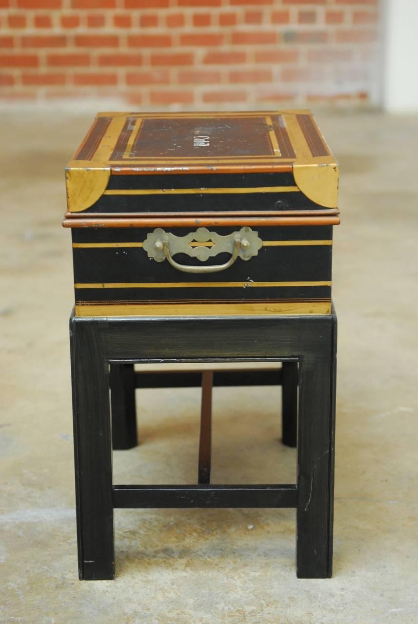 Rare British colonial officer's campaign field desk on stand. Constructed from metal and brass featuring a royal blue painted finish with gilt highlights. The top opens to a fitted interior complete with storage bins and cutglass ink wells with