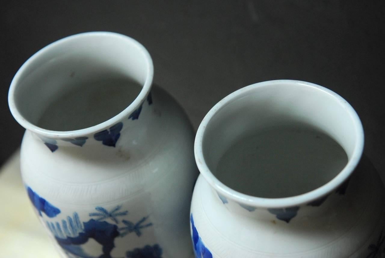 Interesting pair of Chinese blue and white porcelain cylinder vases depicting the Immortals with Shaolao riding in a crane above. Decorated in the Kangxi Period style in blue and white with both vases unmarked on bottom. Scrolled impressions around