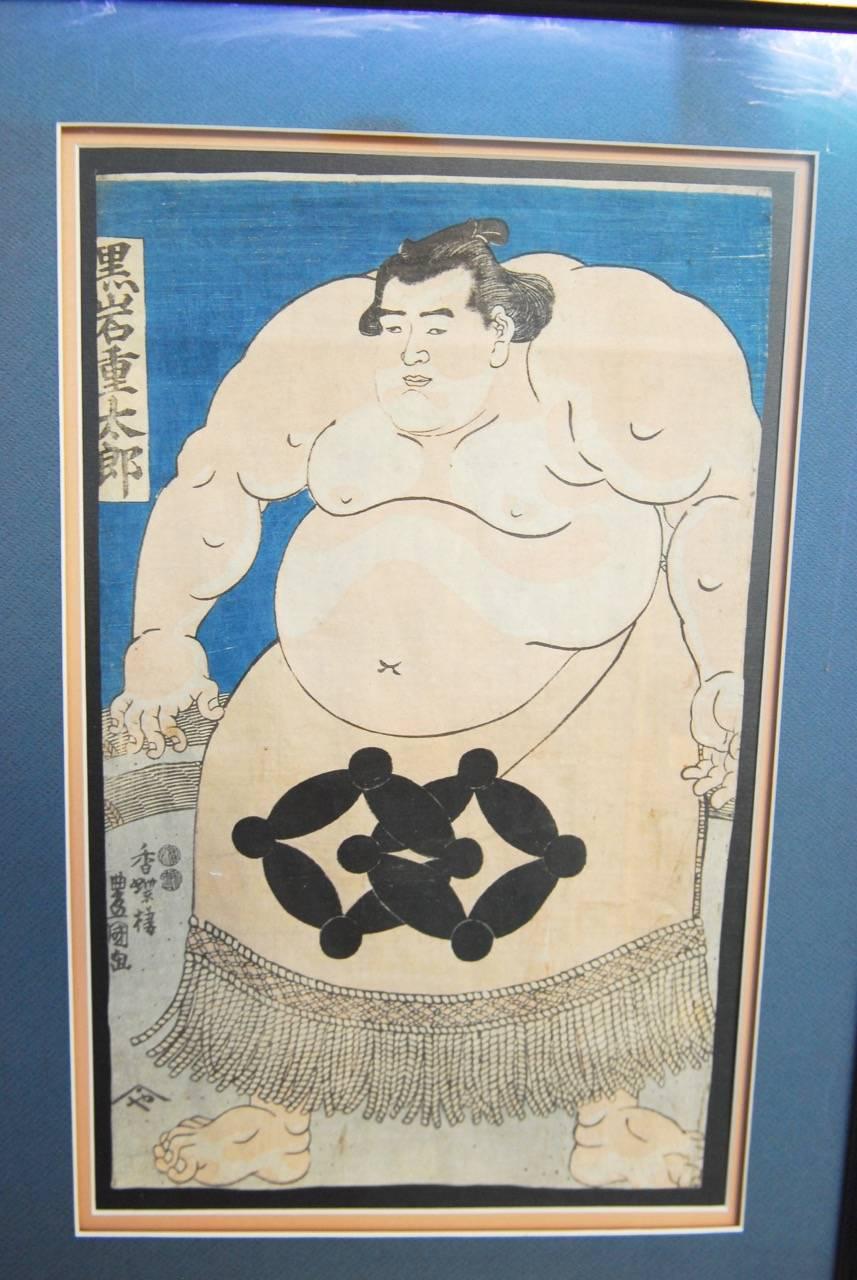 Unique Japanese woodblock print of sumo wrestler Kuroiwa Jutaro by one of Japan's famous artists Utagawa Kunisada (Toyokuni III) (1786-1865). Set in an ebonized wood frame with a museum quality conservation glass framing. Signature and seals on