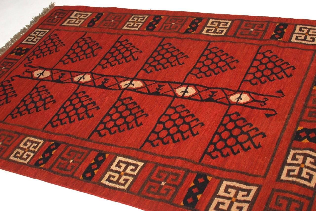 Distinctive Afghan flatweave carpet featuring a tribal style with a geometric Greek key motif border.