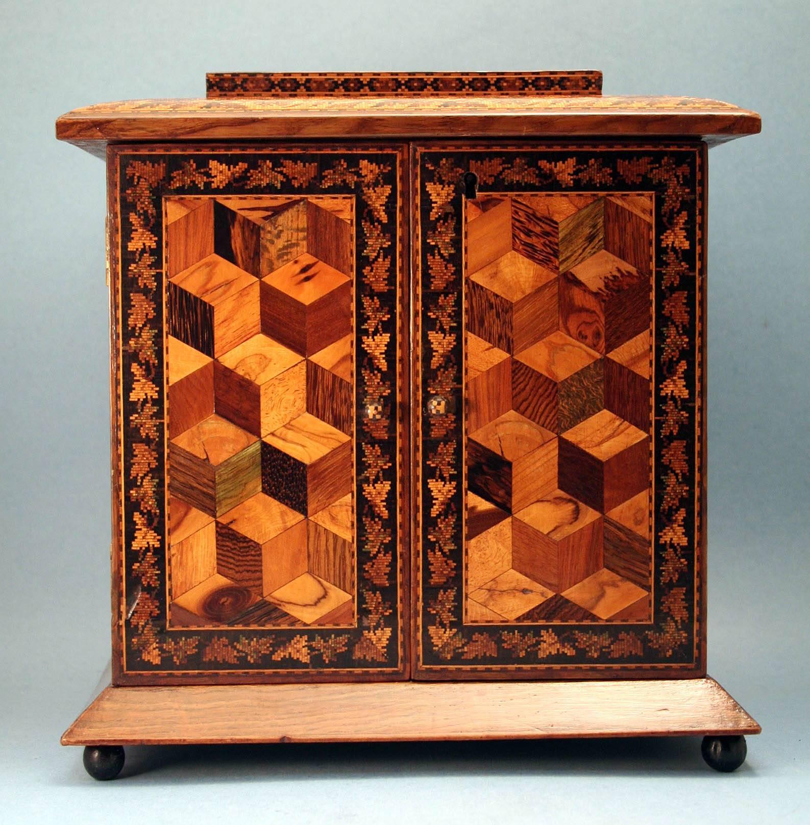 Remarkable antique English tunbridgeware dresser cabinet or jewelry box in olivewood with tessellated mosaic inlaid decoration, having a stepped lid with inlaid castle and floral decoration, two cabinet doors with 
