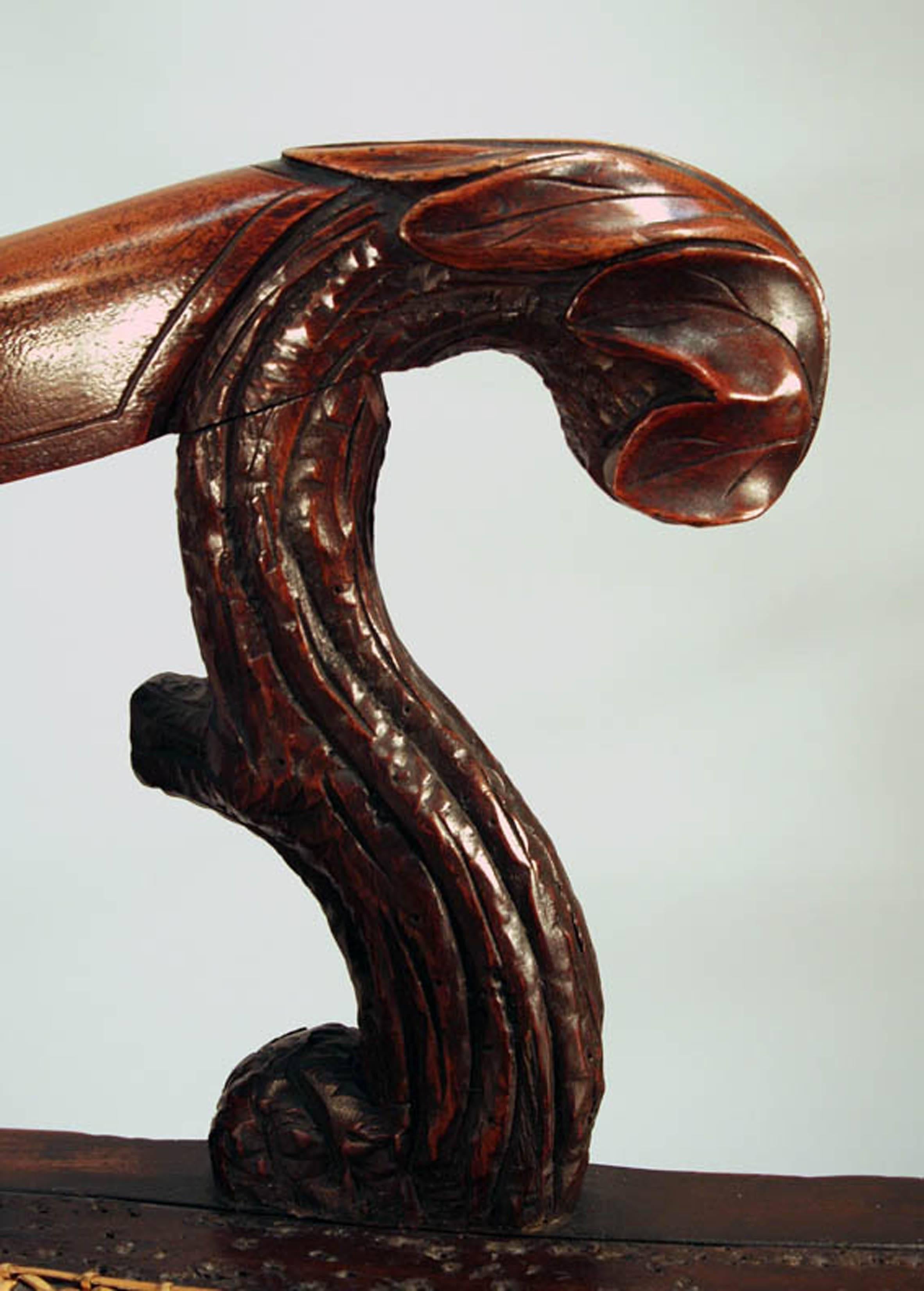 Impressive large-scale Black Forest carved armchair in walnut with all-over carved decoration of bark, branches, leaves and berries, Swiss, circa 1870-1880.

Provenance: Anniee McCarthy, Newport, RI and NYC (label). 

See “History of Black