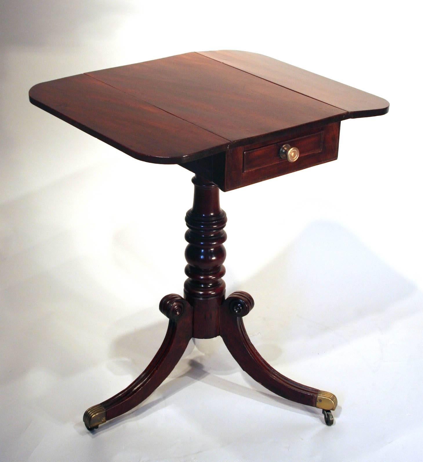 
Fine English Regency Drop-leaf Work Table in mahogany, having a single drawer above a turned pillar and three downswept fluted legs with brass castors. 
Circa 1810-1820
Top Closed: 13” D x 20”W 
Top Open:  24.5” D x 20”W
Height: 28 ”
