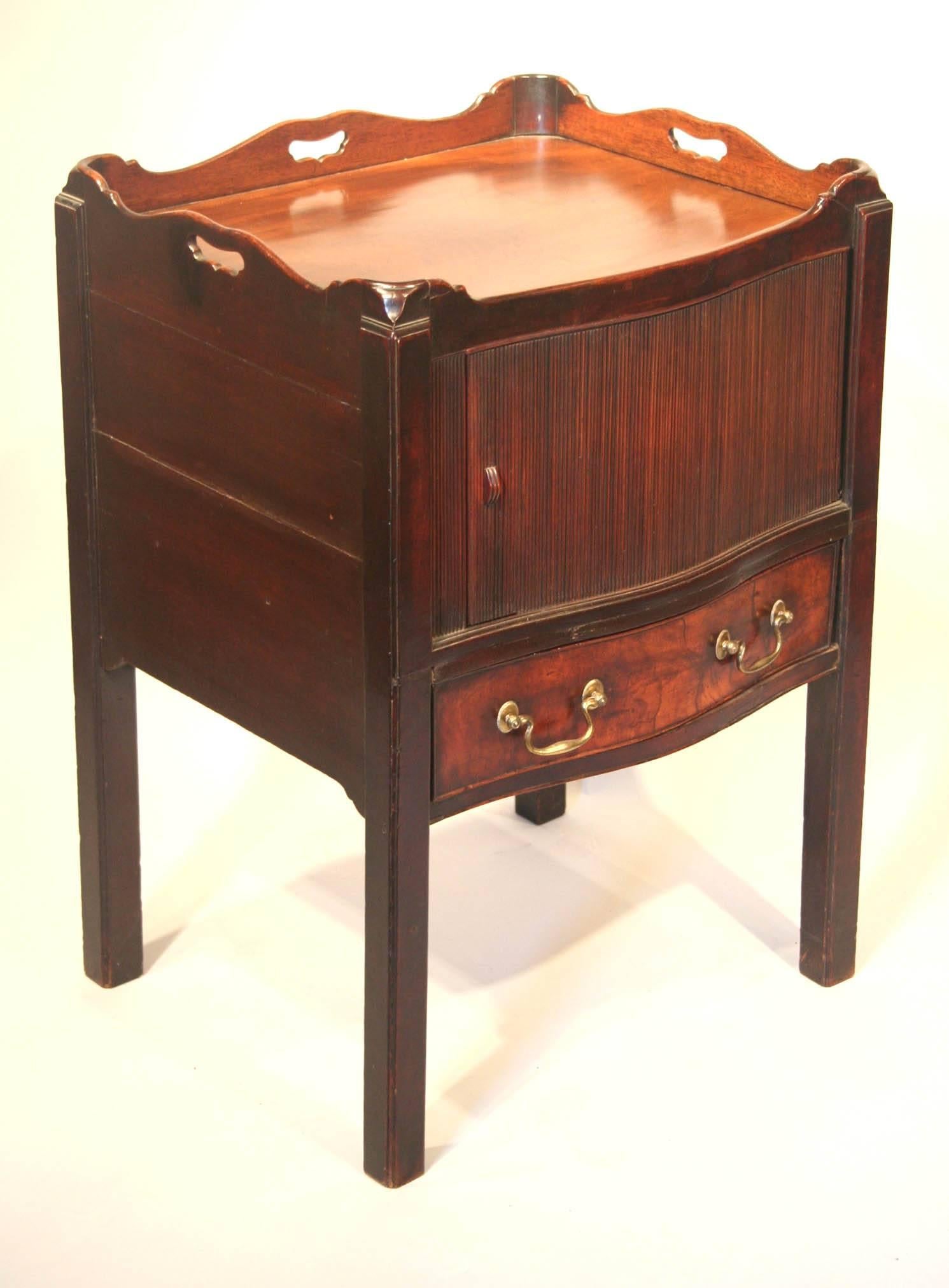 Fine George III bow front commode table in mahogany, having a galleried top above a shaped, tambour door and drawer, raised on straight chamfered legs, English, circa 1780.
 
