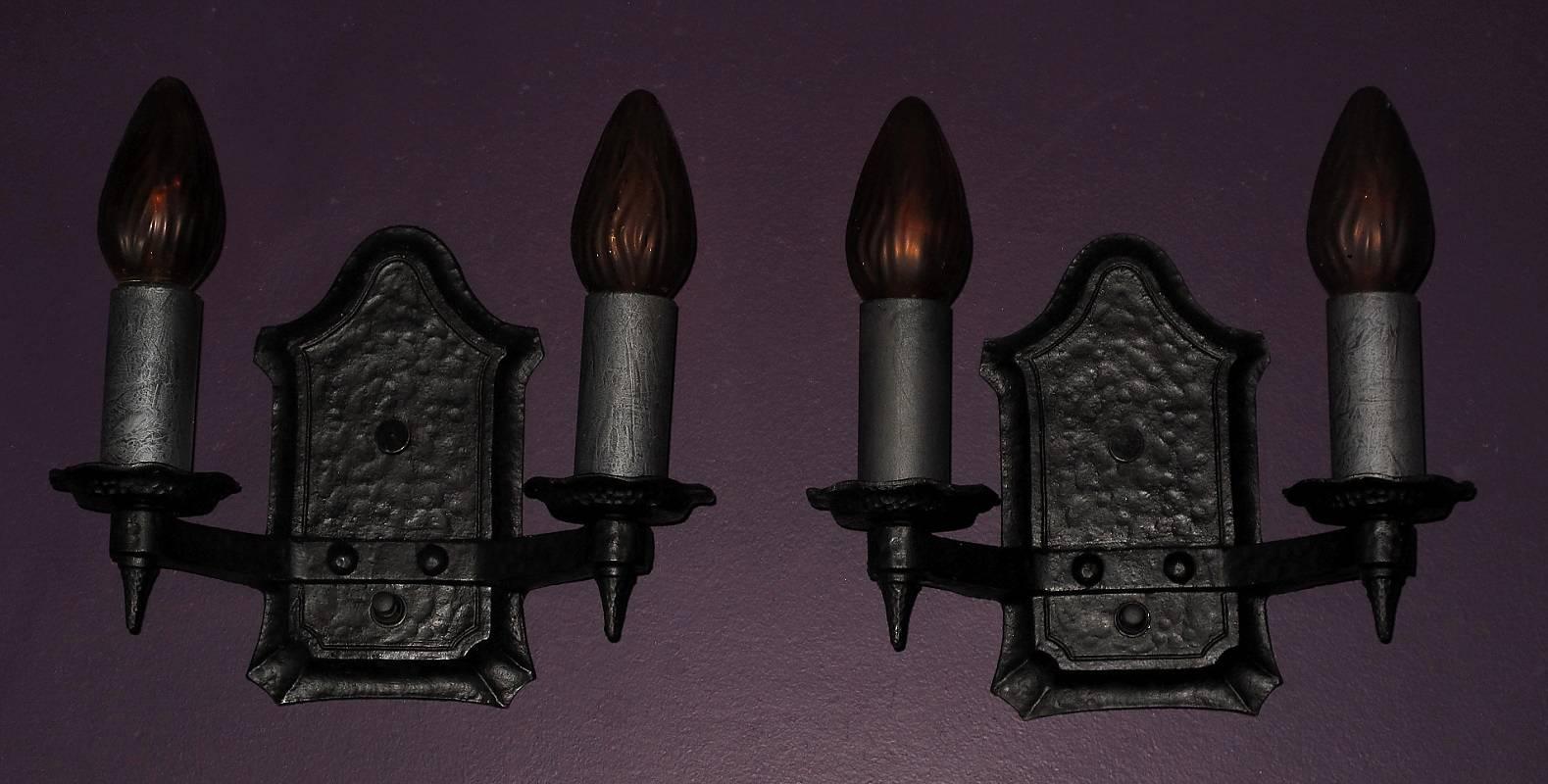 Two pair available, priced per pair. ADA Compliant.
 Designed to appeal to both the craftsman style and the revival styles (Spanish revival) of their day with the hammered look cast into the iron and the little upside down spires under each socket.