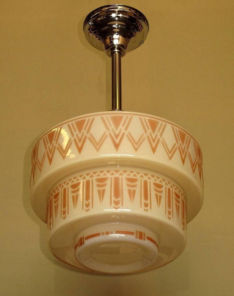 1930s era custard shade on new nickel fitter. Wonderful Art Deco design all around each of the three-tier sides of the shade. No noticeable paint loss or fading in the paint. The custard glass shade is in excellent condition as well. 
 Highly