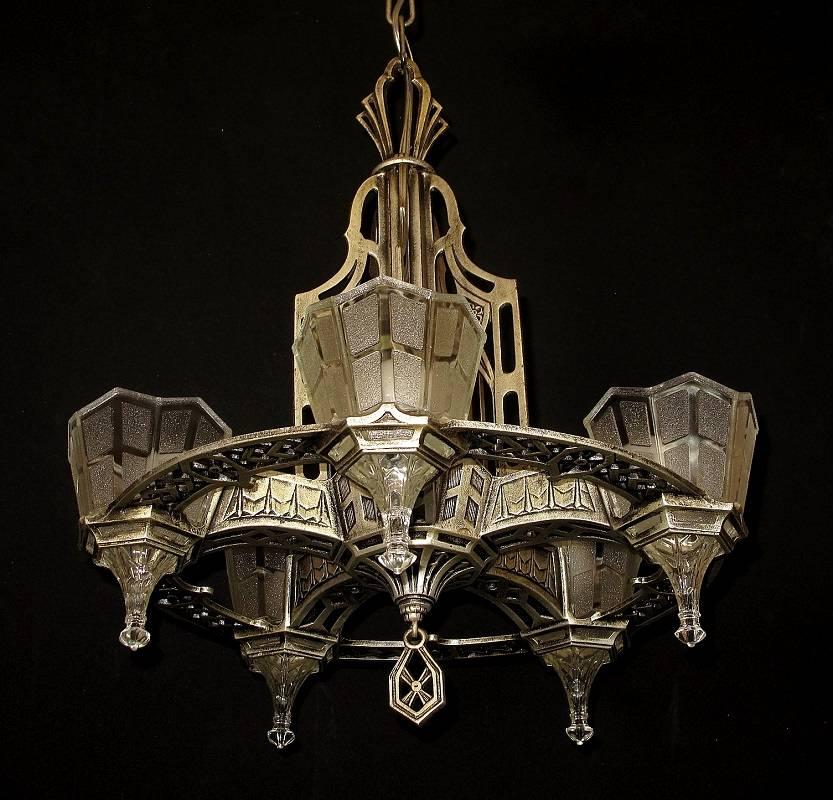 With a definite Tudor/Gothic look this 1920s-1930s fixture is a wonderful example of the European influence which was a very popular design style during the 1920s and into the early 1930s. This fixture retains it original finish and patina with just