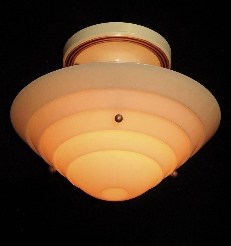 From the 1930s when designers were heading full tilt into the Mid-Century style. All original parts, except updated wiring and it has been restored to its original color scheme of cream fixture with antique golden highlights which really set off the