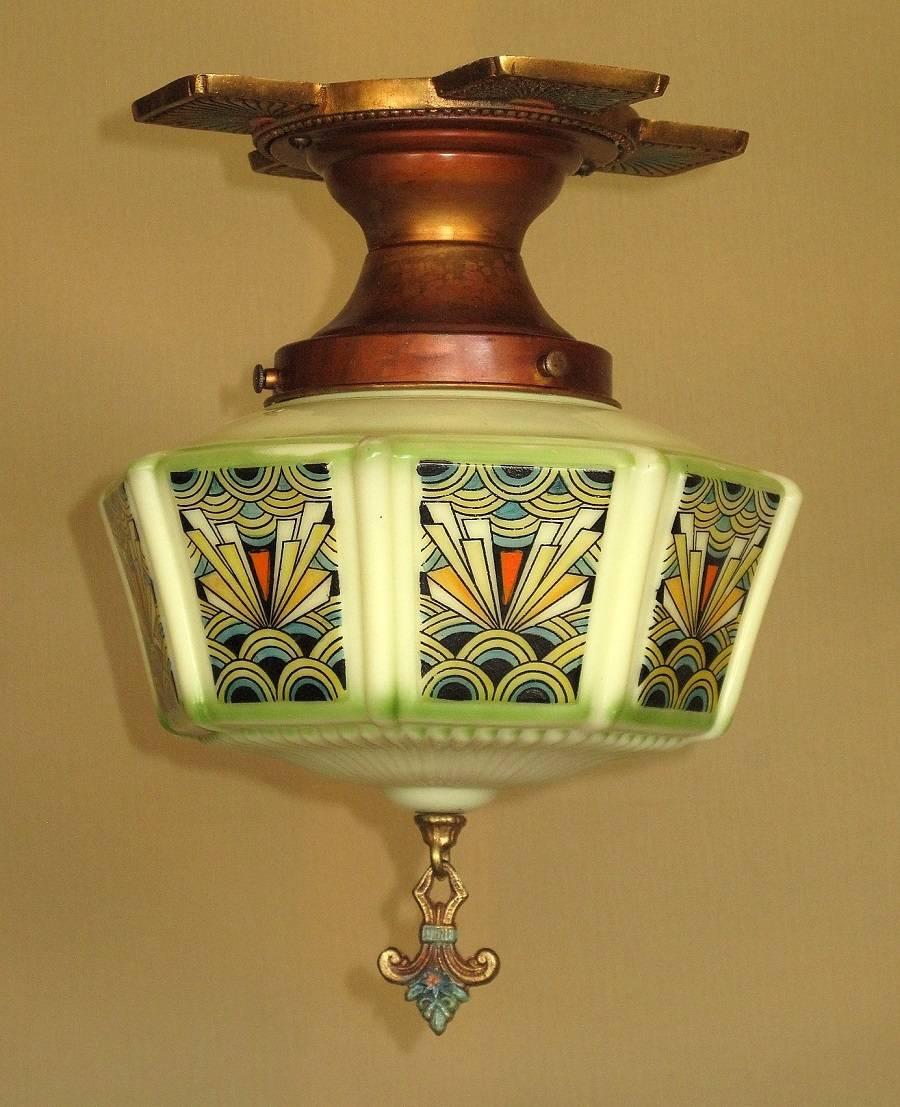 Wonderfully vibrant and colorful Art Deco custard glass shade design by Gill Glass Co. On original Gill Glass fitter with original Gill Glass bottom finial. The black outlined design is pure deco. Eight panels of 1/2 round circles in blue and yellow