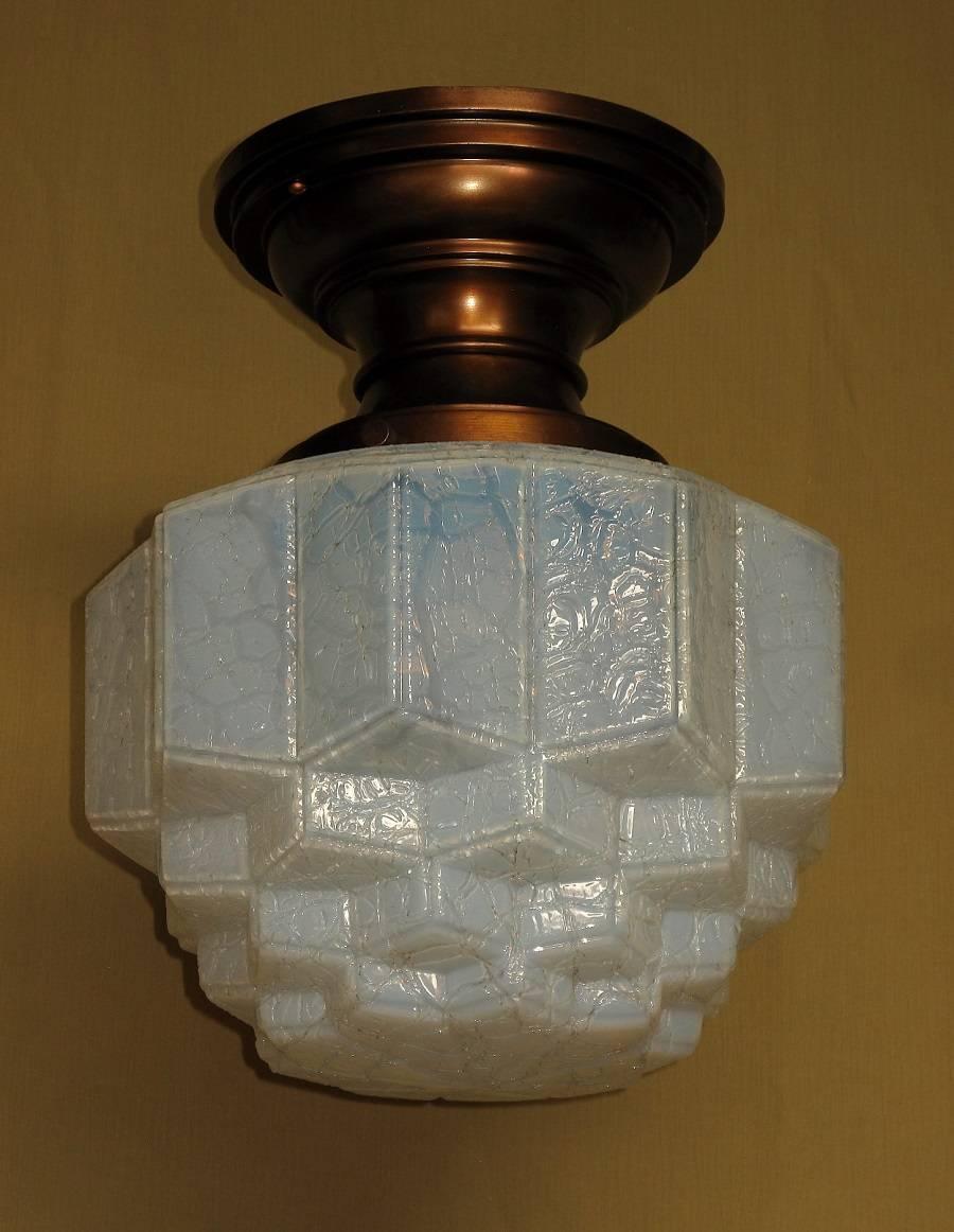 This unique fixture is one you do not see every day, in fact this is the first one we can remember seeing in 18 years. we have had several blue crackle glass shades in the past but never one with this coloration or shade.
The shade shows a light