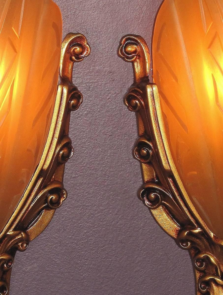 4 pair available, priced per pair.
 These cast iron sconces are very well made with crisp detailing, great Art Deco influenced design, and great proportions, all which you would expect from the manufacturer Moe Bridges Co. of Milwaukee. Refinished