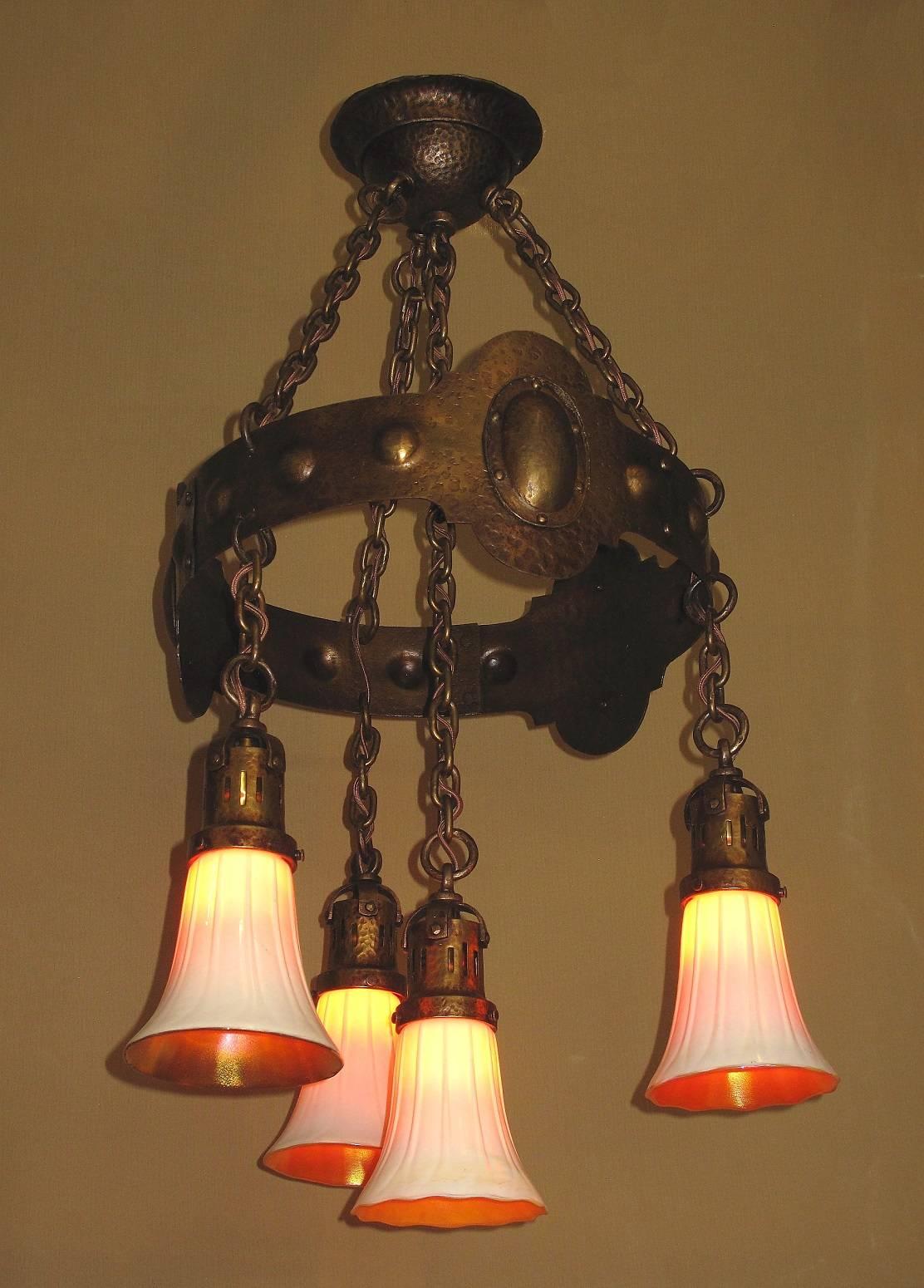 Incredibly rare to find a fixture this old in this immaculate of a preserved condition. All original finish and patina, including the chain and socket covers. Hammered brass metal. We just gently washed it and applied a light coat of wax to help