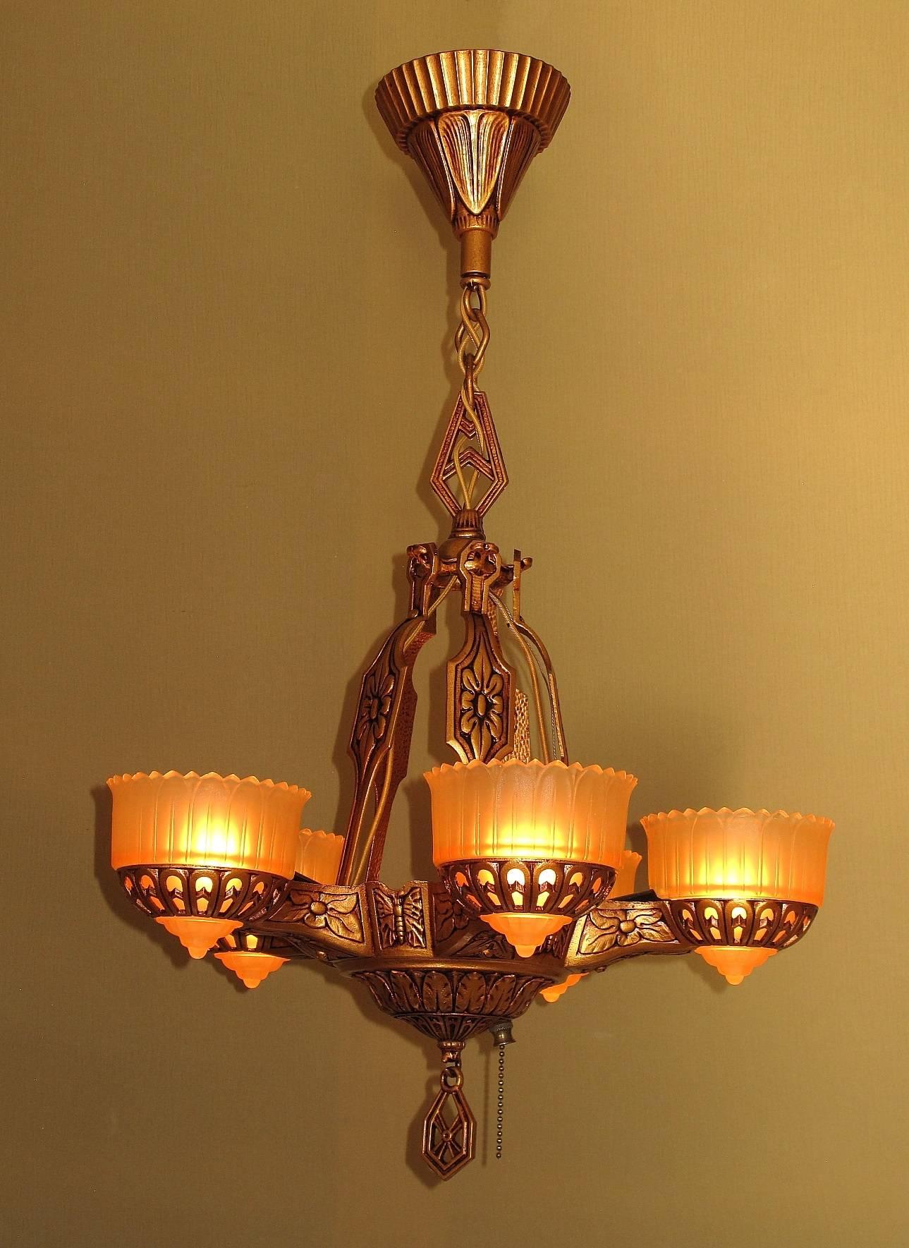 This would date to the late 1920s or early 1930s when Art Deco was in full bloom. Unique aspect of this chandelier, besides it's superb design and style, are butterflies which are cast between each arm of the fixture. Deco inspired floral patterns