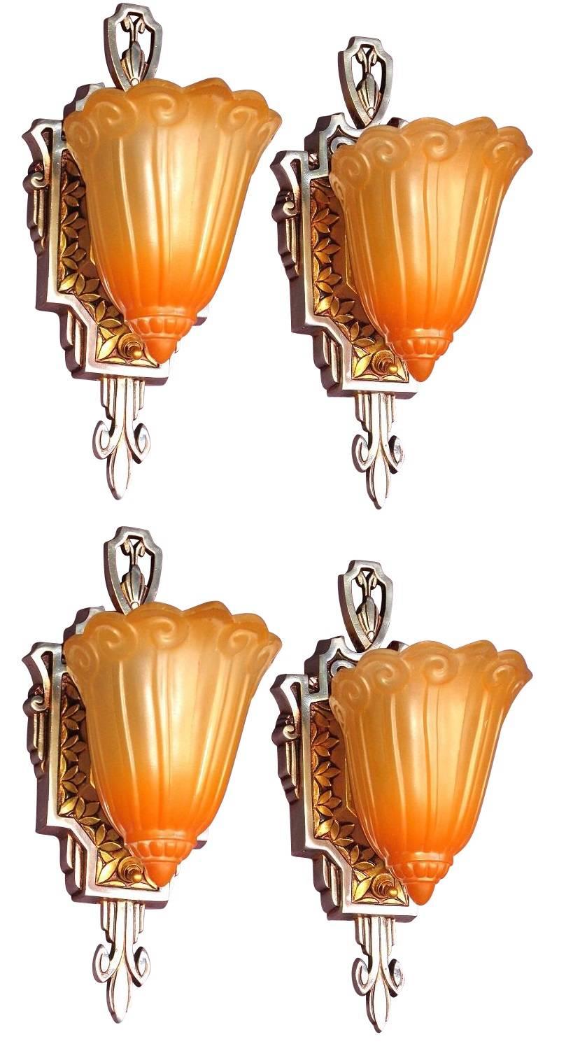 Restored to their original glory with highly polished aluminum accents and sides, repainted in their original color of sunset golden highlighting the spectacular Art Deco design, and original orange tinted shades. New sockets, wiring and new painted