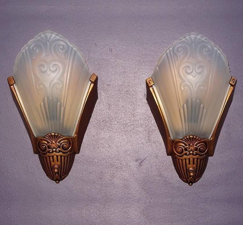 Simple and elegant vintage slip shade wall sconces by Virden of Milwaukee. Three pair available. Priced per pair (per piece).
Dates to late 1920s through the 1930s, the Art Deco period of American design. Solid cast back with clear frosted shades
