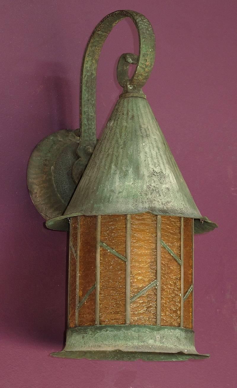 Porch light made primarily of copper with the curved arm between the back plate and the top of the witches hat shade made of copper plated aluminum, circa 1925. Original as found condition which shows the rich, slightly green patina that copper
