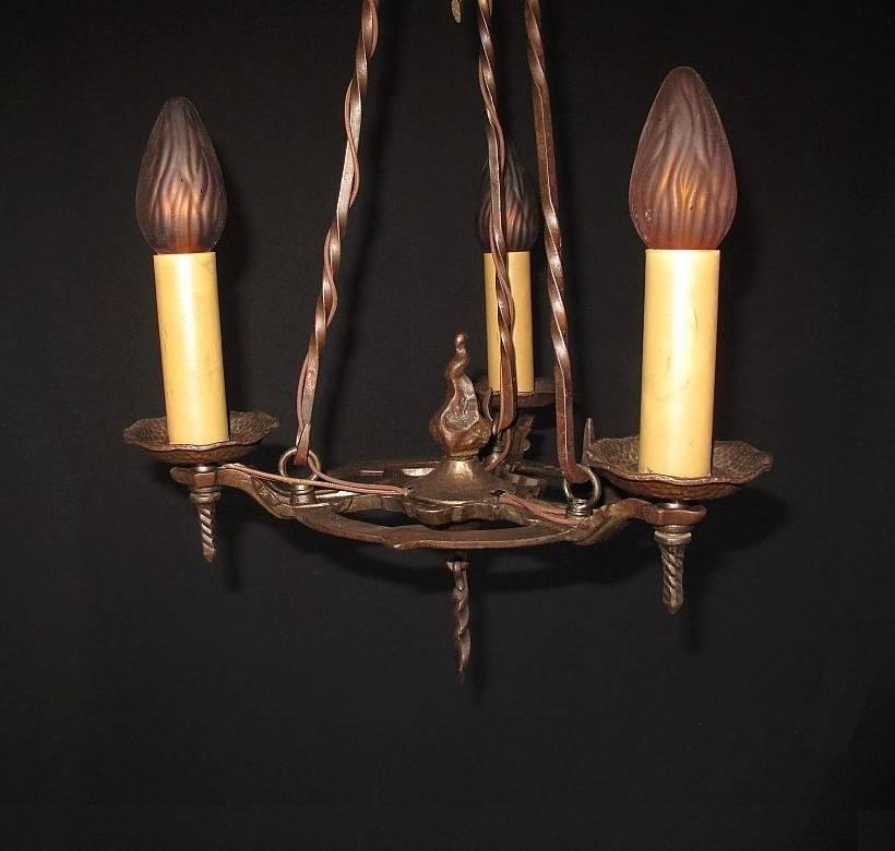 Early 20th century cast iron antique ceiling light fixture which retains its original finish and patina. Lightly waxed to protect its well deserved aged look. 100% original (including candle sleeves) except for the updated wiring. The three risers