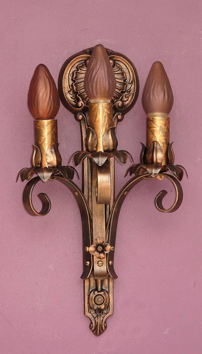 Wonderful vintage three-arm wall sconces. Classic in design and style with a wonderful shell rosette at top giving them a slight nautical feel. All of these antique sconces are signed 