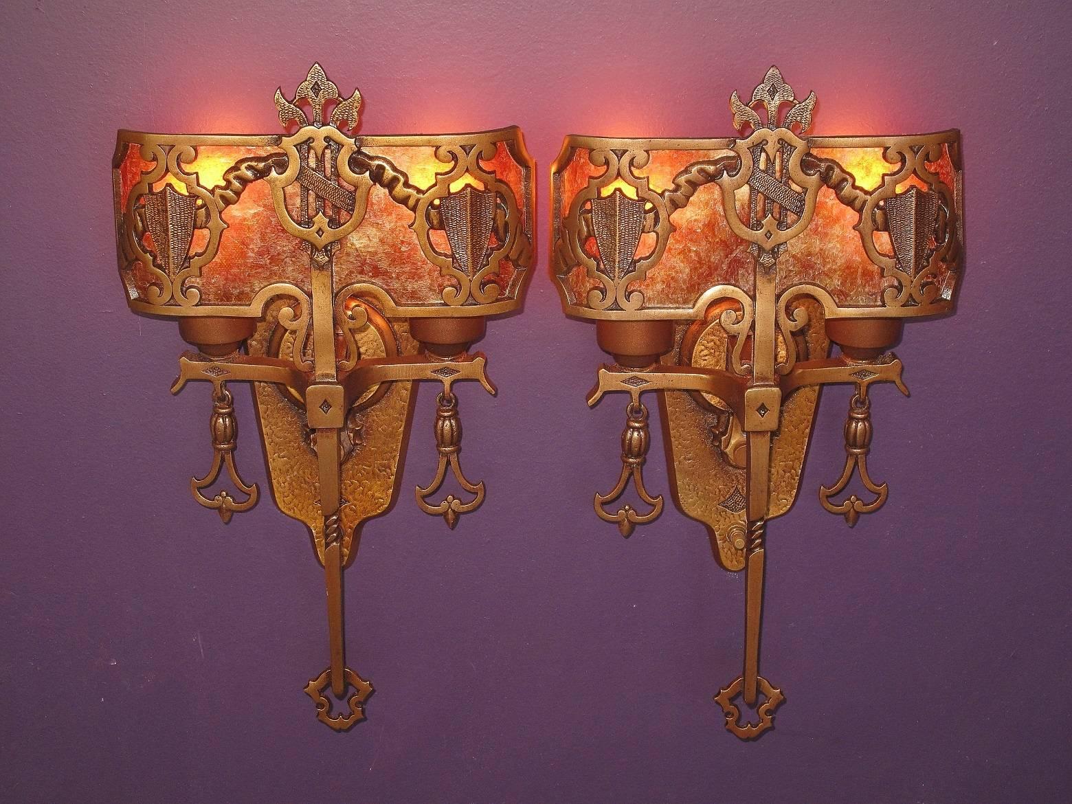 Solid bronze two bulb Tudor/Spanish Revival style vintage, 1920s wall sconces. Renewed finish and light bulbs have a new amber mica shade. Nice complement to any Spanish Revival or Tudor home.
Measures: Height 15 1/4 inches.
Width 8 1/2